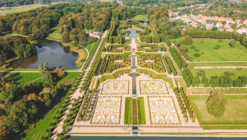 The Baroque Garden at Frederiksborg Castle seen from the air with symmetric paths and the opal lake.